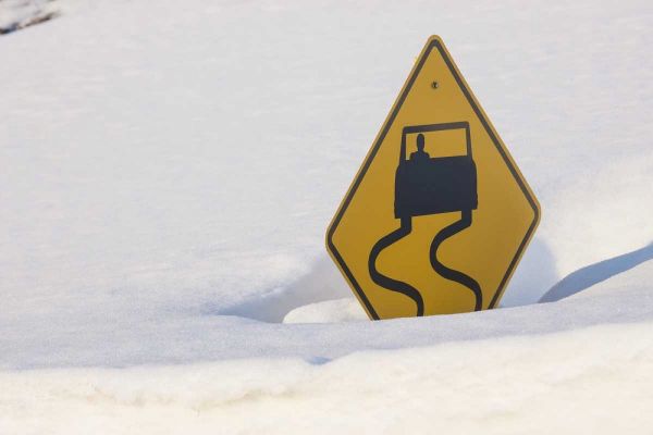 Colorado A slippery when wet sign buried in snow